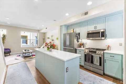 a kitchen with a sink stove and refrigerator