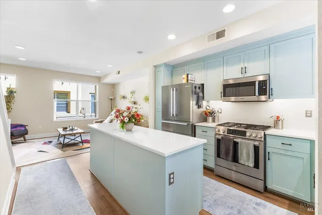 a kitchen with a sink stove and refrigerator