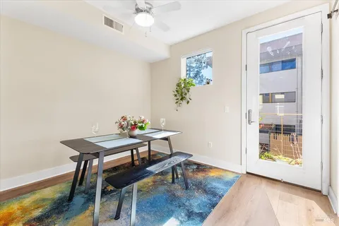 a view of a dining room with furniture and wooden floor