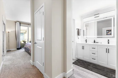 a bathroom with a sink mirror and a toilet