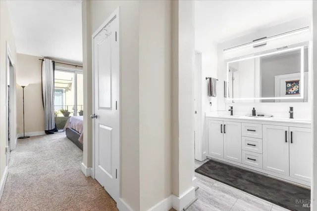 a bathroom with a sink mirror and a toilet
