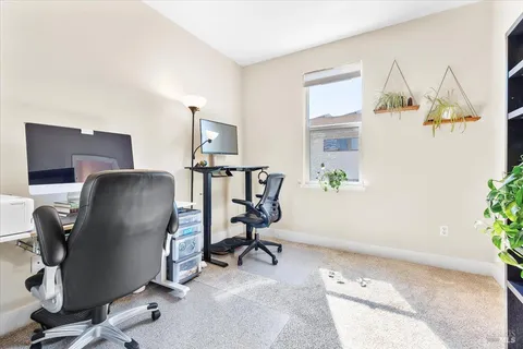 a view of workspace with mirror and lounge chair