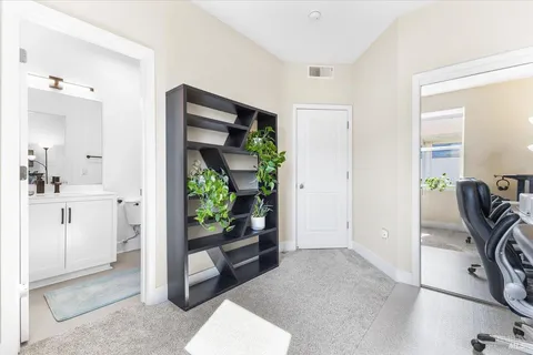 a view of a hallway with dining room and front door