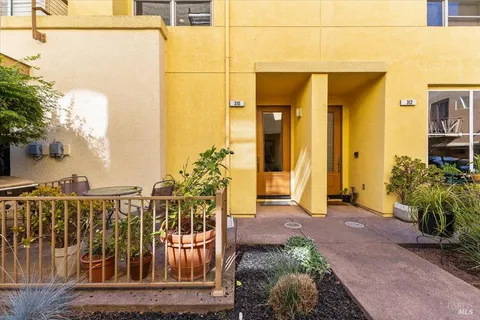 a view of a balcony with potted plants