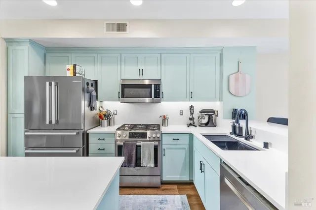 a kitchen with a sink a stove and refrigerator