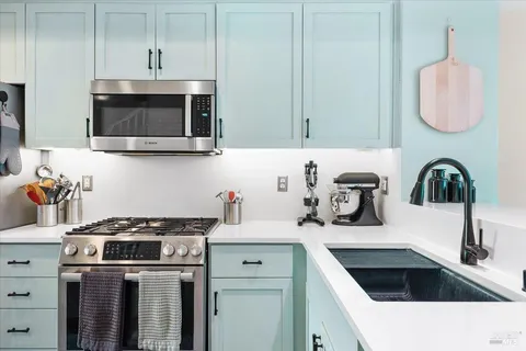 a kitchen with a sink stove and microwave