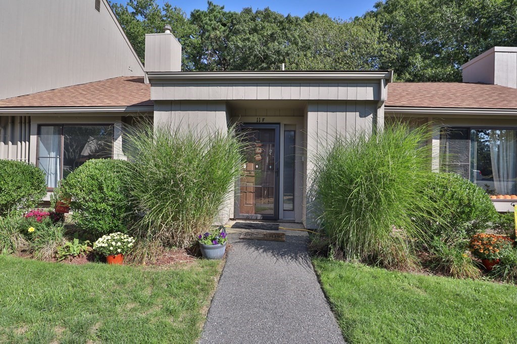 481 Buck Island Road, Unit 11F Yarmouth, MA 02673 - Photo 1 of 28 a front view of a house with garden