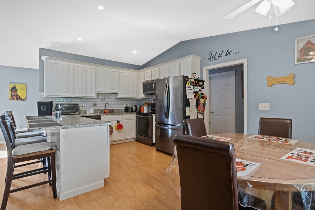 481 Buck Island Road, Unit 11F Yarmouth, MA 02673 - Photo 15 of 28 a kitchen with a refrigerator and a stove top oven