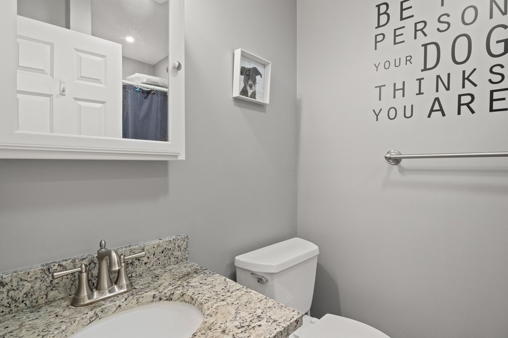 481 Buck Island Road, Unit 11F Yarmouth, MA 02673 - Photo 22 of 28 a bathroom with a toilet sink and mirror