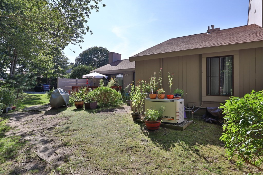 481 Buck Island Road, Unit 11F Yarmouth, MA 02673 - Photo 25 of 28 a front view of a house with a yard
