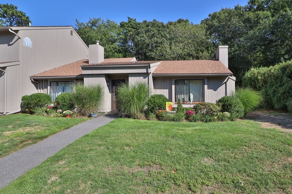 481 Buck Island Road, Unit 11F Yarmouth, MA 02673 - Photo 6 of 28 a view of a house with a yard and potted plants