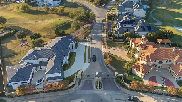 an aerial view of residential houses with outdoor space and ocean view