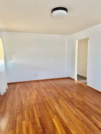 a view of an empty room and wooden floor
