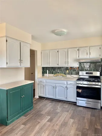 a kitchen with stainless steel appliances granite countertop a stove and a sink
