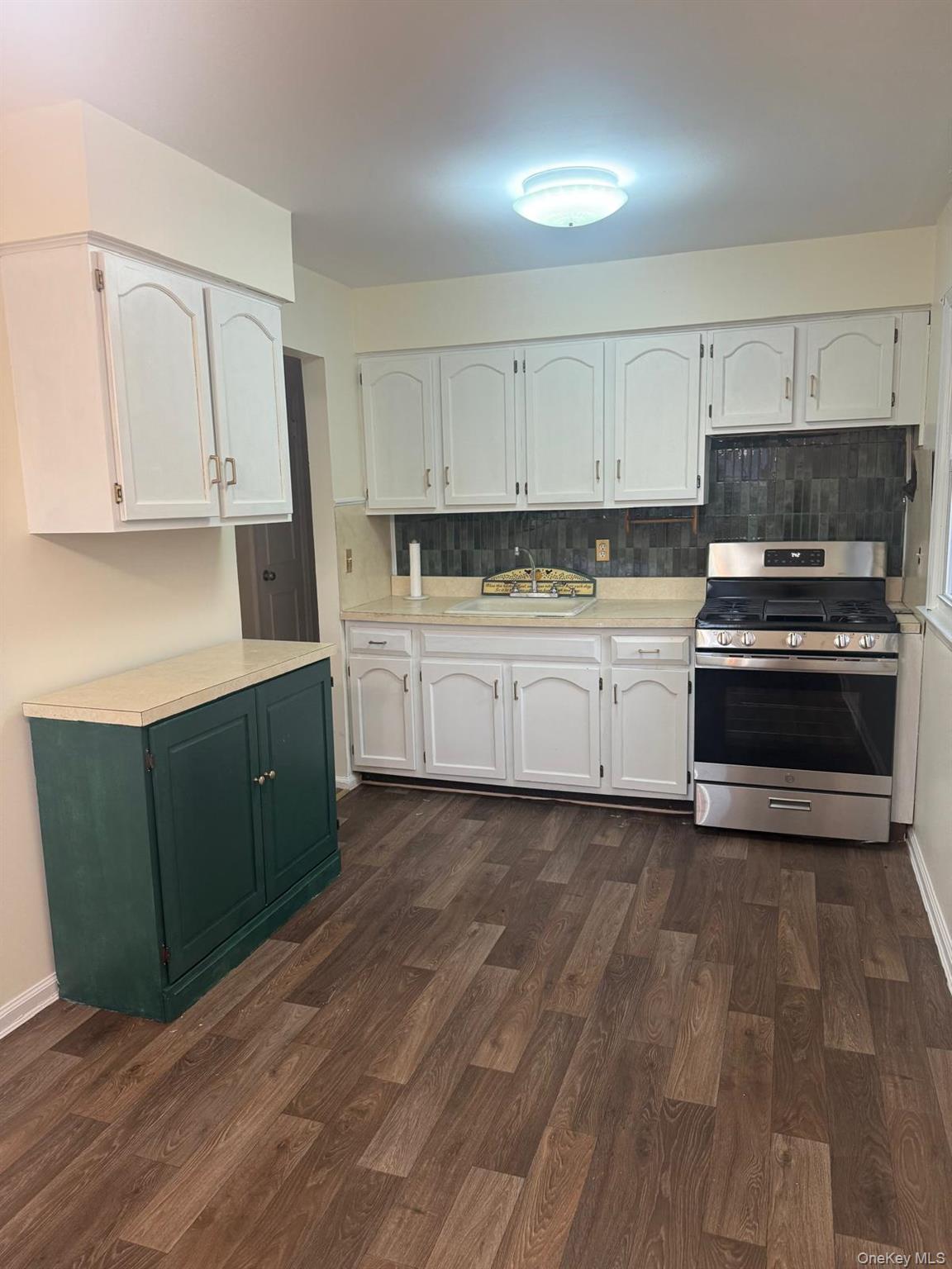 110 Evergreen Avenue, Unit 2 Lynbrook, NY 11563 - Photo 6 of 18 a kitchen with stainless steel appliances granite countertop a stove a sink and a refrigerator