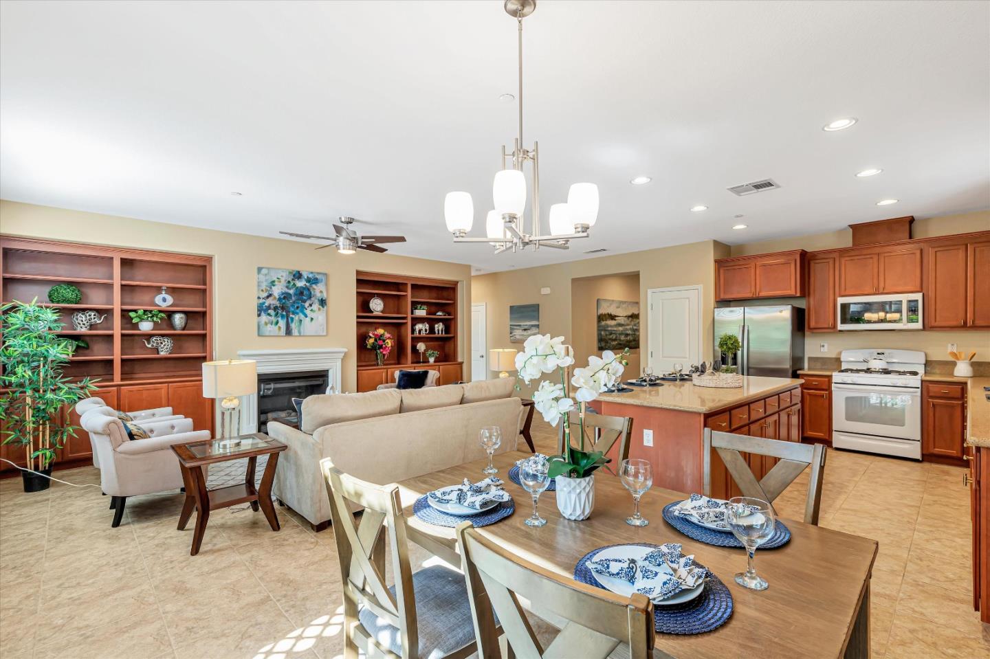 9545 Grande Drive Gilroy, CA 95020 - Photo 11 of 28 a living room with furniture a dining table and a chandelier