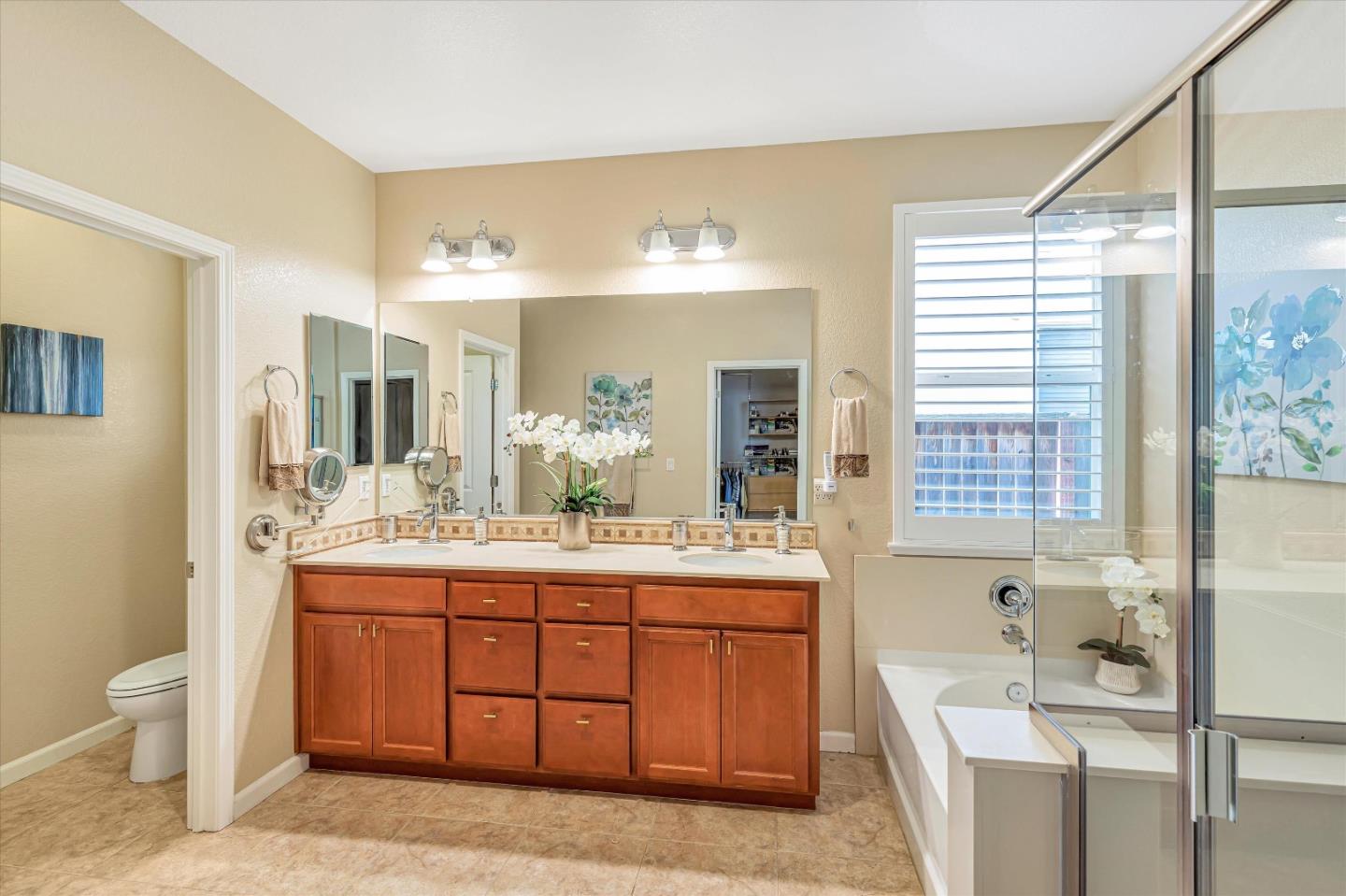 9545 Grande Drive Gilroy, CA 95020 - Photo 19 of 28 a bathroom with a sink double vanity mirror and a toilet