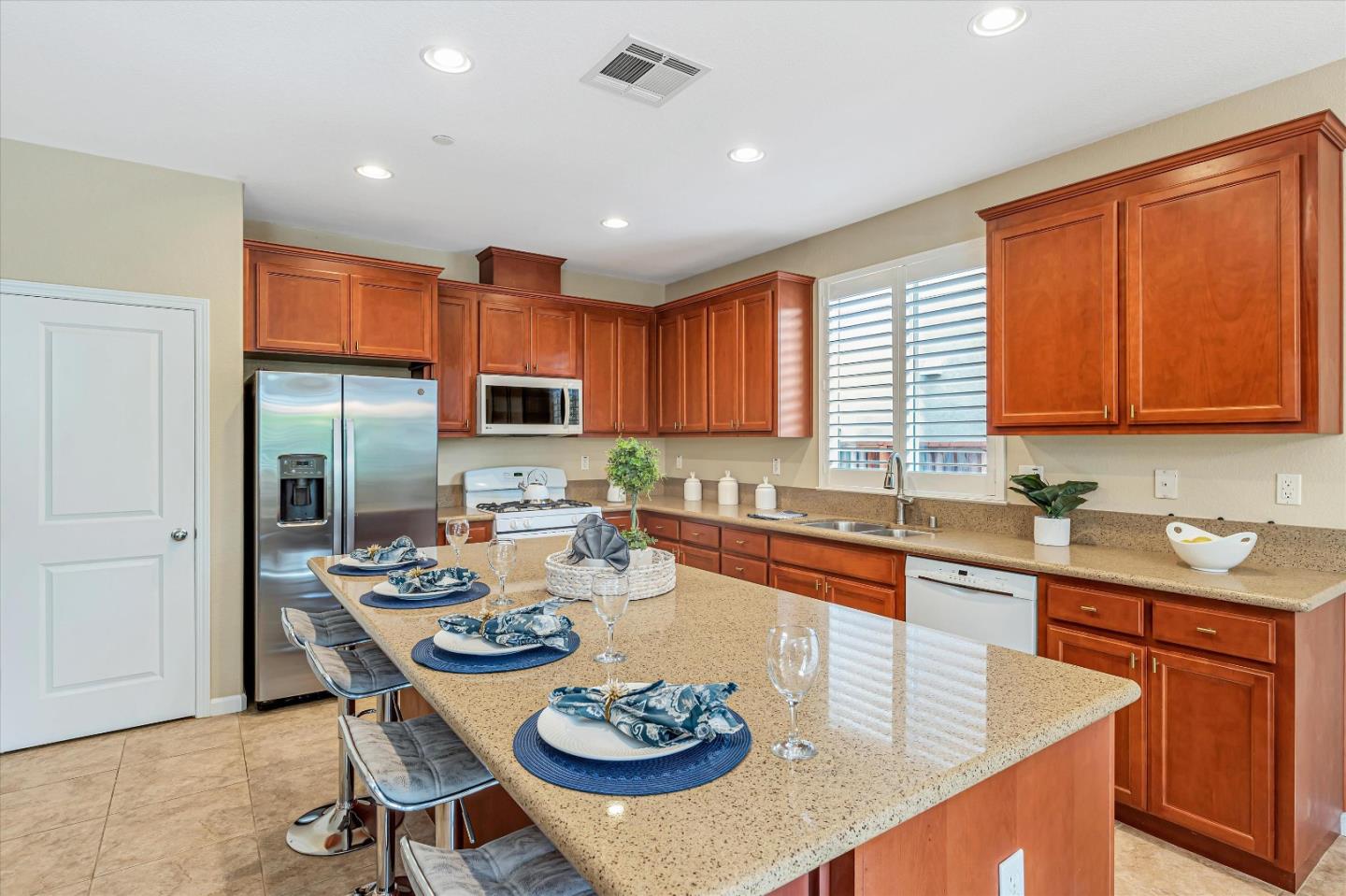 9545 Grande Drive Gilroy, CA 95020 - Photo 8 of 28 a kitchen with a dining table chairs and refrigerator