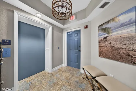 a view of a hallway to a livingroom and furniture