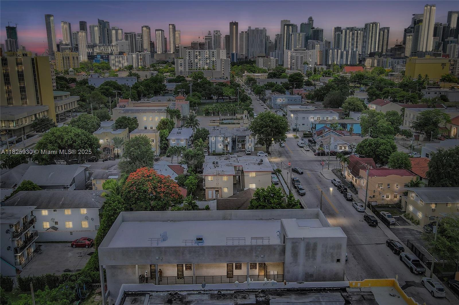 an aerial view of multiple houses with a yard