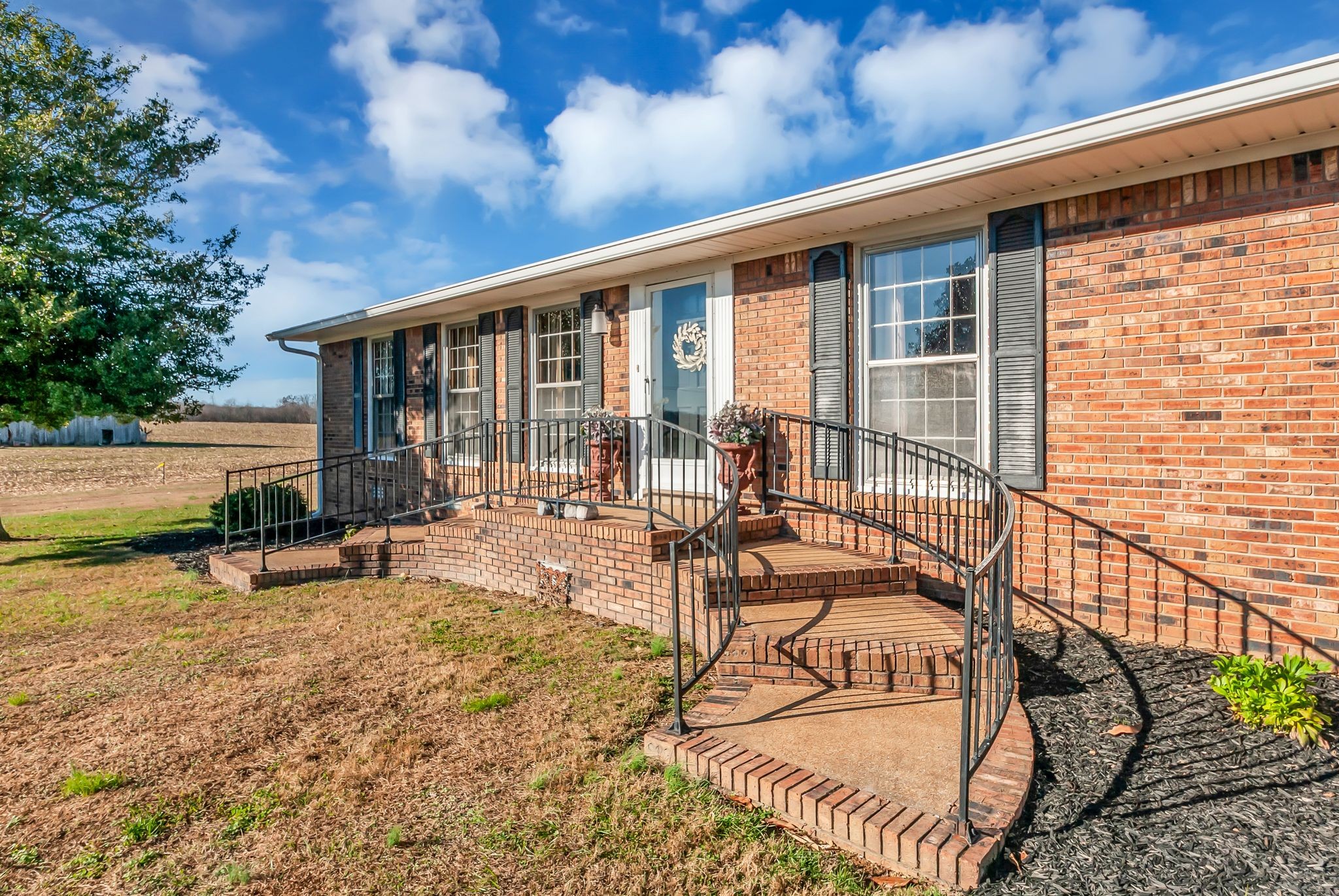 a view of a house with backyard and sitting area