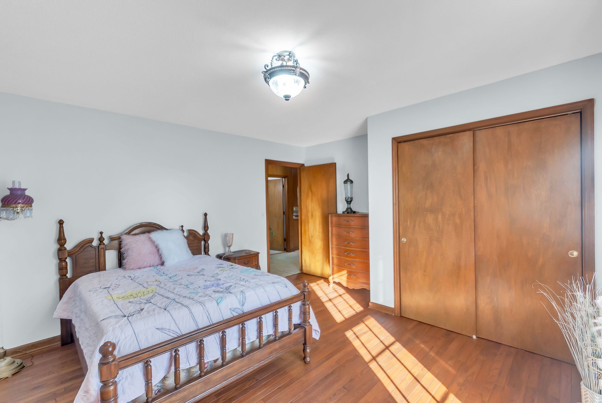 104 Glendale Road Loretto, TN 38469 - Photo 26 of 46 a bedroom with a large bed and a chandelier