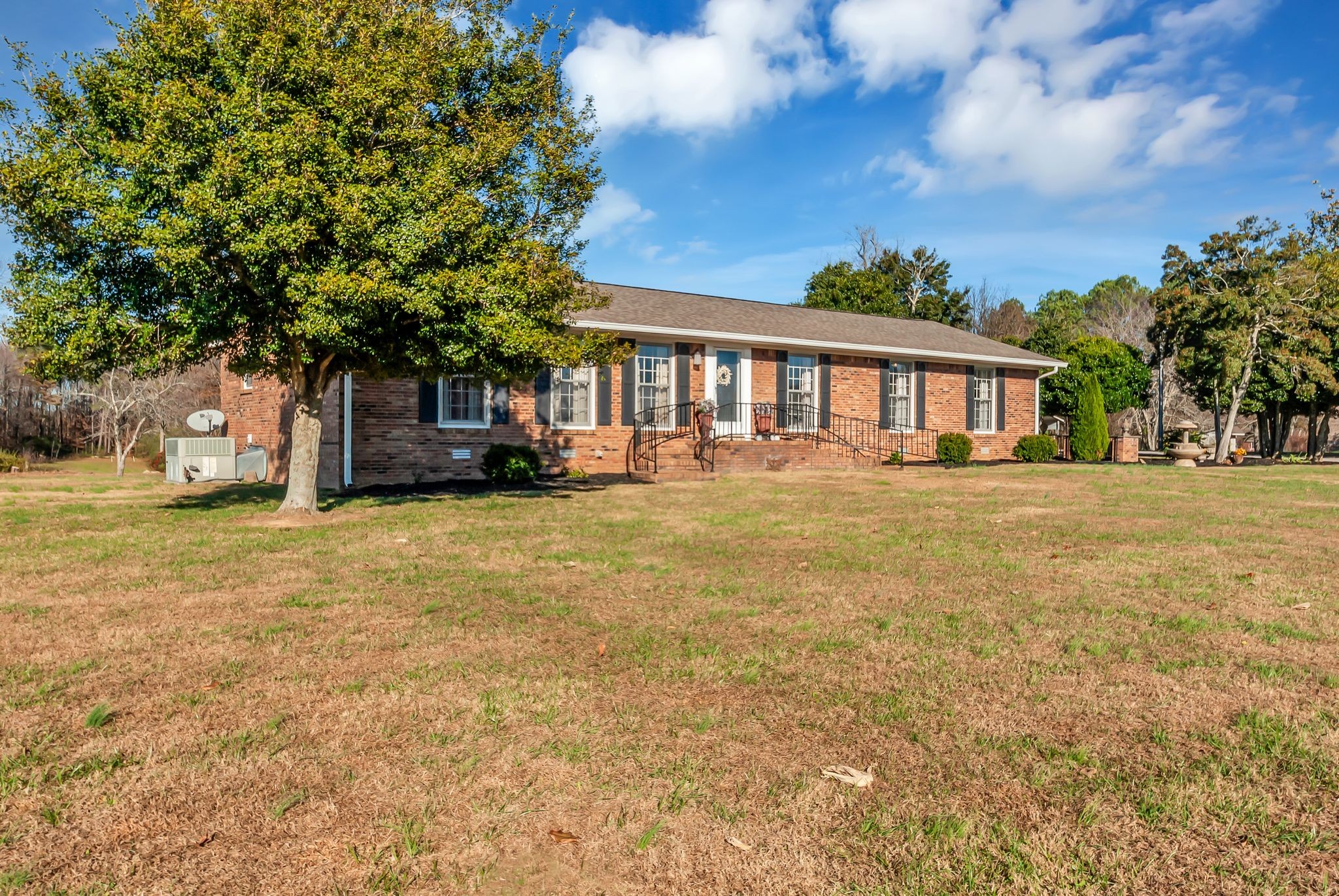 104 Glendale Road Loretto, TN 38469 - Photo 4 of 45 a front view of a house with a garden and trees