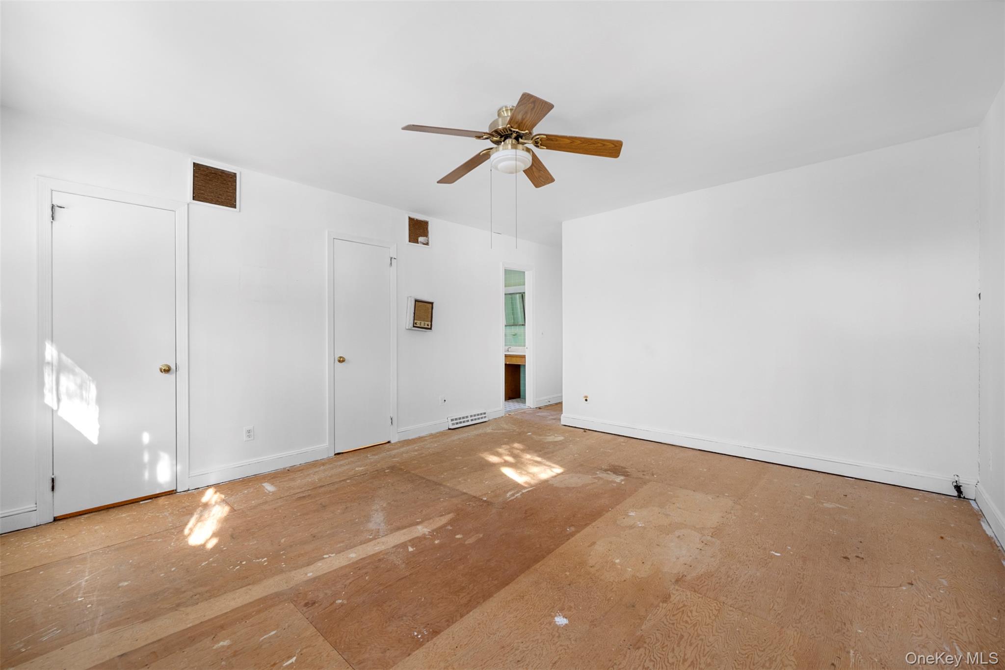 66 Deepdale Drive Great Neck, NY 11021 - Photo 20 of 48 an empty room with windows and fan