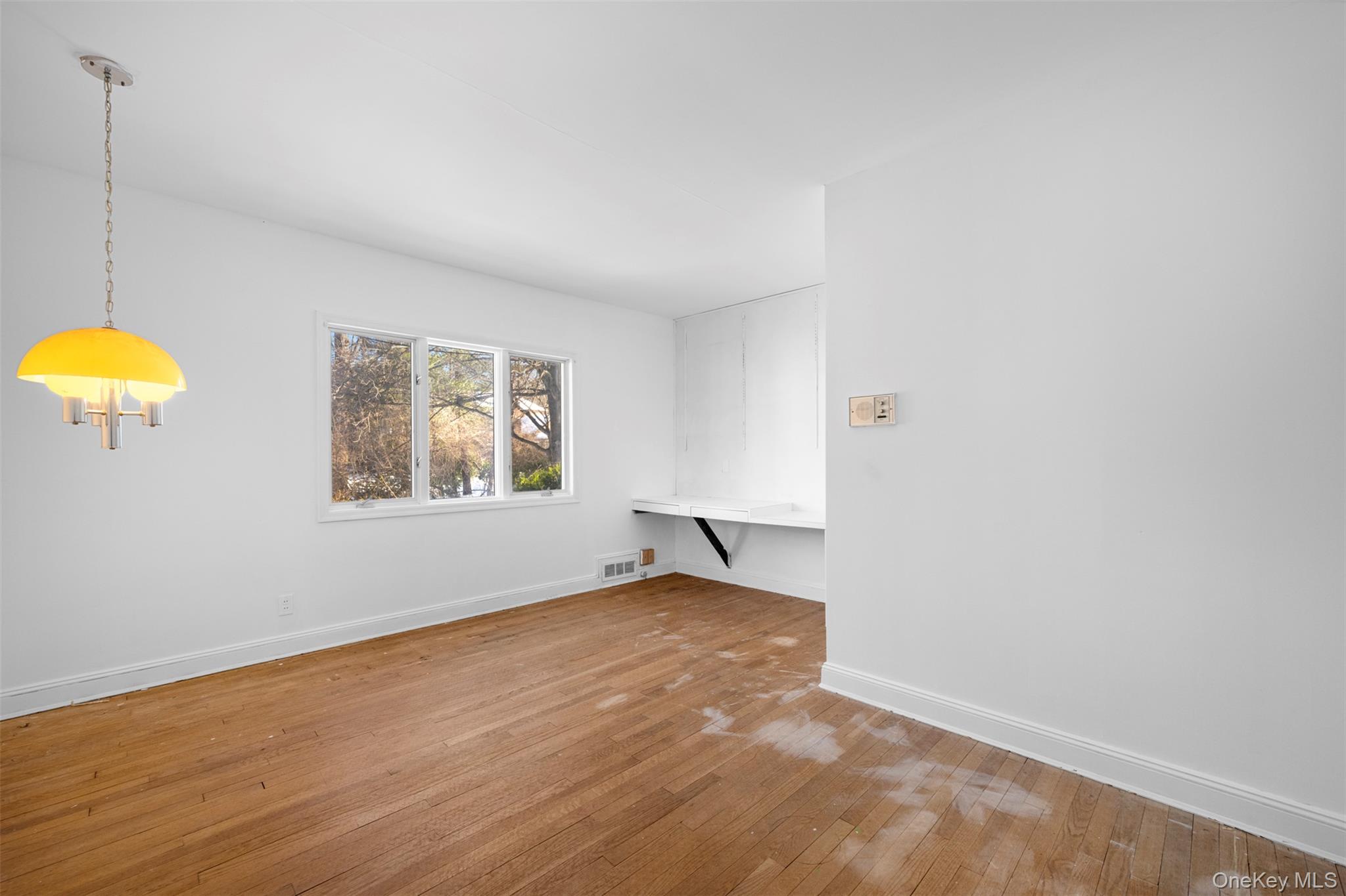 66 Deepdale Drive Great Neck, NY 11021 - Photo 28 of 48 an empty room with a window and wooden floor