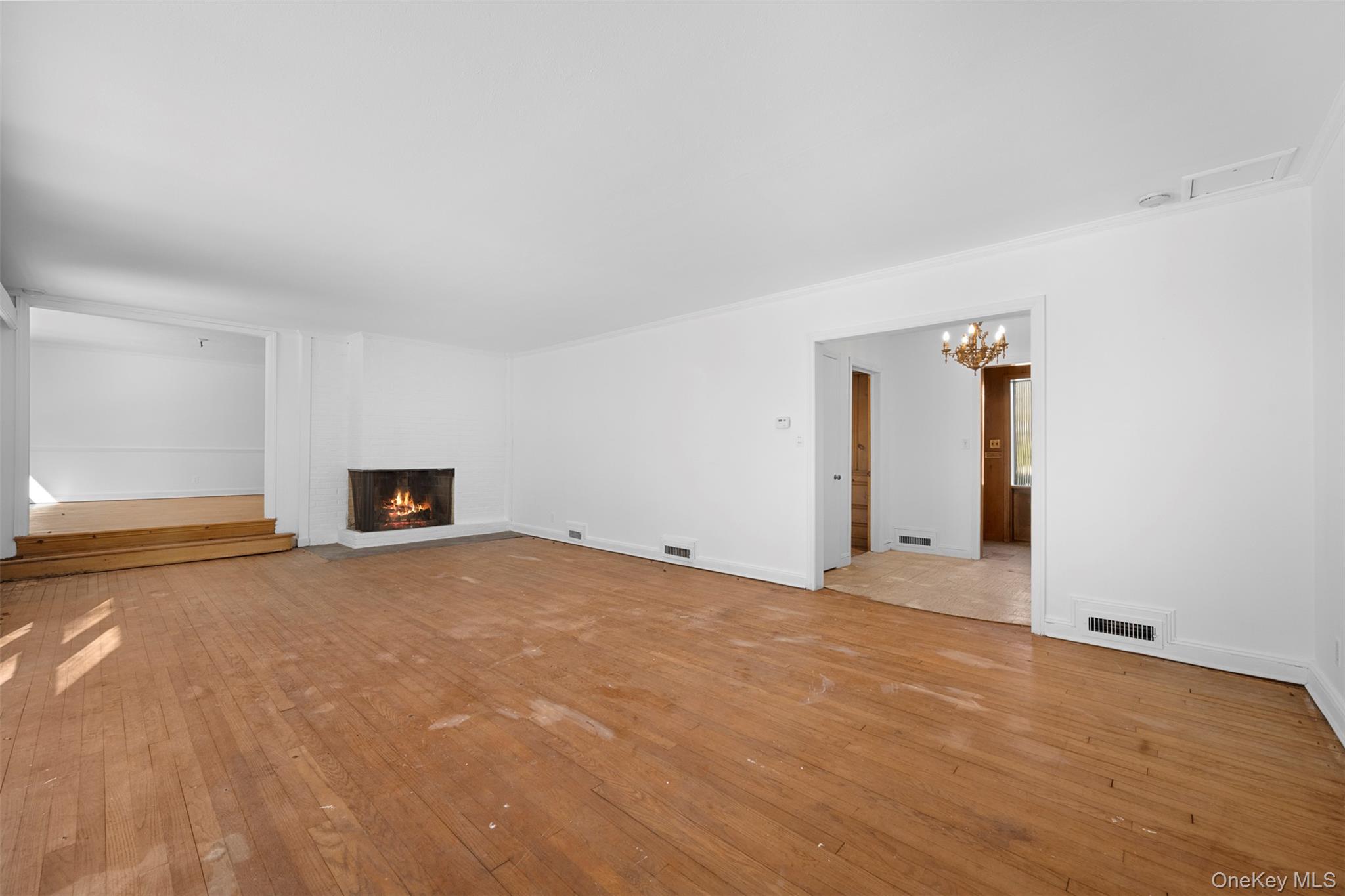 66 Deepdale Drive Great Neck, NY 11021 - Photo 4 of 48 a view of an empty room with window and a kitchen