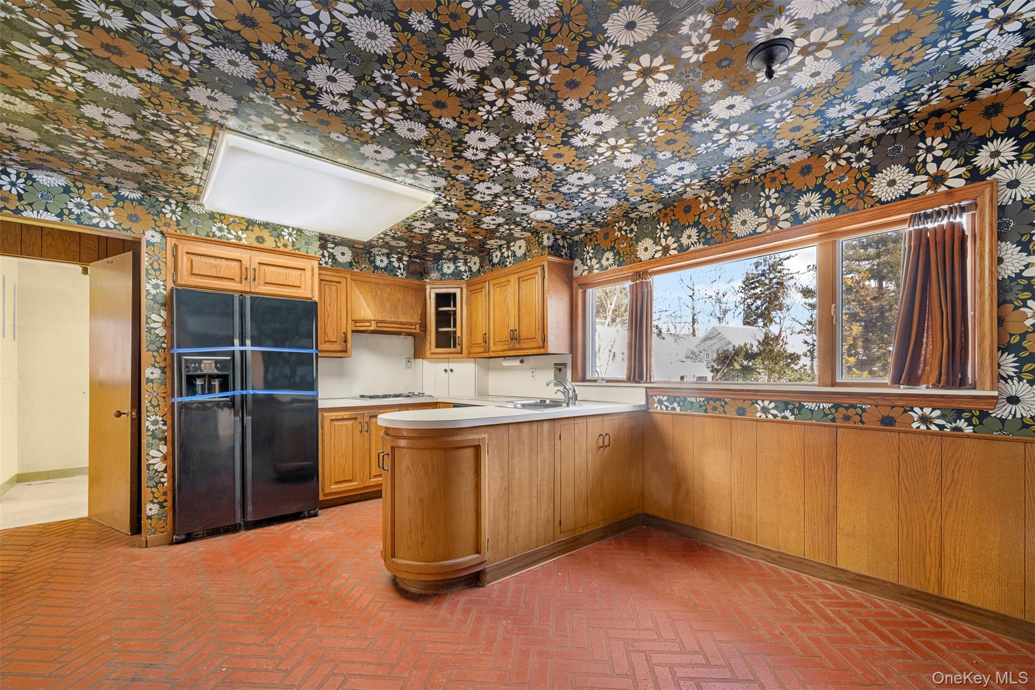 66 Deepdale Drive Great Neck, NY 11021 - Photo 10 of 48 a view of a large kitchen with a large tree