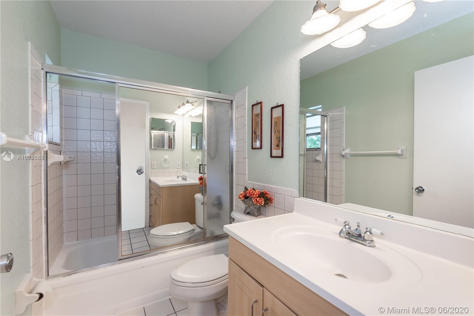 8884 Southwest 6th Street Boca Raton, FL 33433 - Photo 24 of 39 a bathroom with a sink a toilet and shower