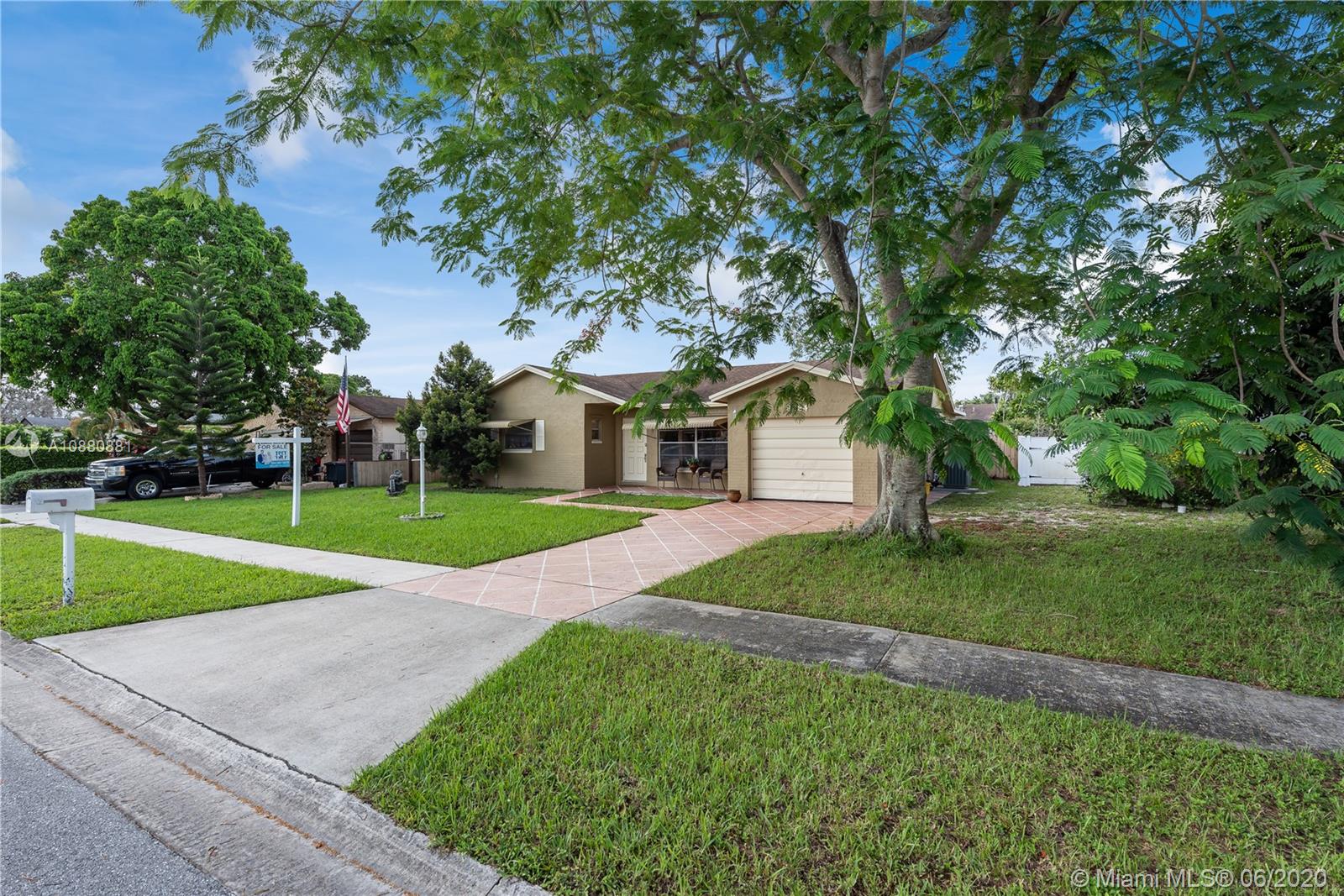 8884 Southwest 6th Street Boca Raton, FL 33433 - Photo 3 of 39 a front view of a house with garden