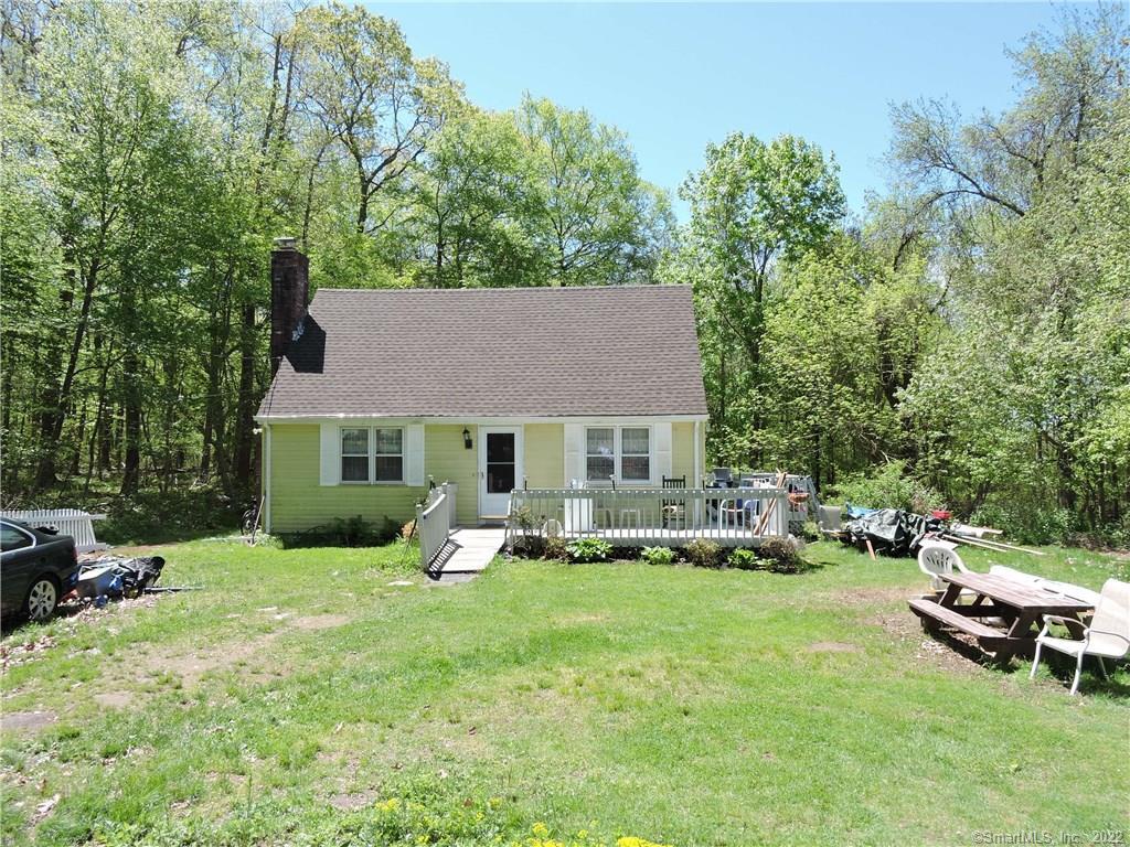 a view of a house with a yard patio and sitting area
