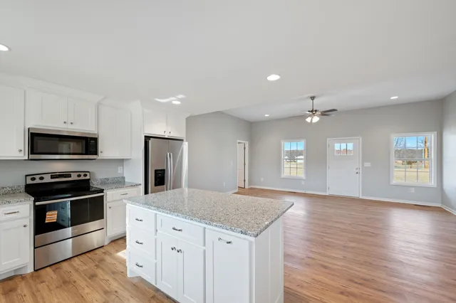 a kitchen with granite countertop a stove and a sink
