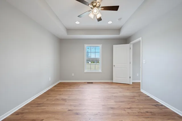 wooden floor in an empty room with a window
