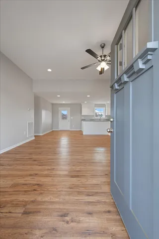 a view of empty room with wooden floor