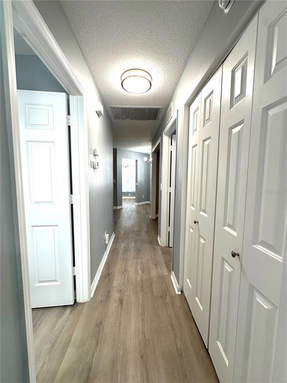 9706 Southwest 92nd Place Road Ocala, FL 34481 - Photo 22 of 82 a view of a hallway with wooden floor and staircase