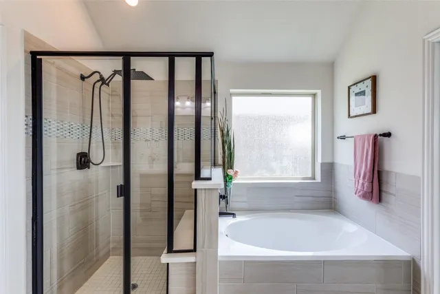 a bathroom with a bathtub and a shower