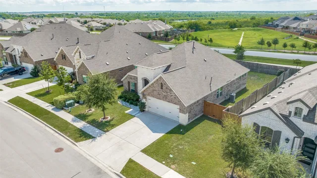 an aerial view of a house with a garden and lake view