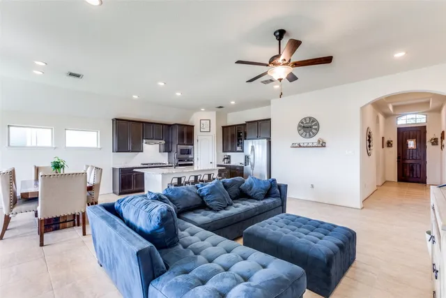 a living room with furniture and kitchen view