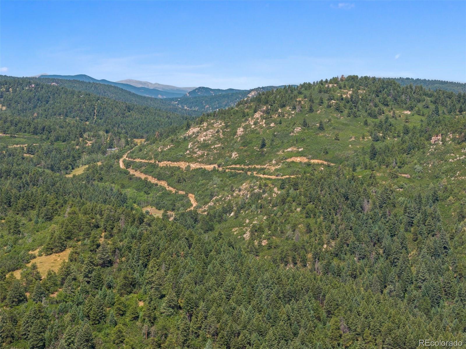 12954 South Kuehster Road Littleton, CO 80127 - Photo 23 of 43 a view of a mountain range with lush green forest
