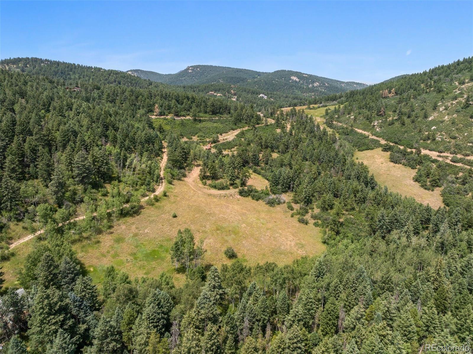 12954 South Kuehster Road Littleton, CO 80127 - Photo 38 of 43 a view of a mountain range with trees in the background