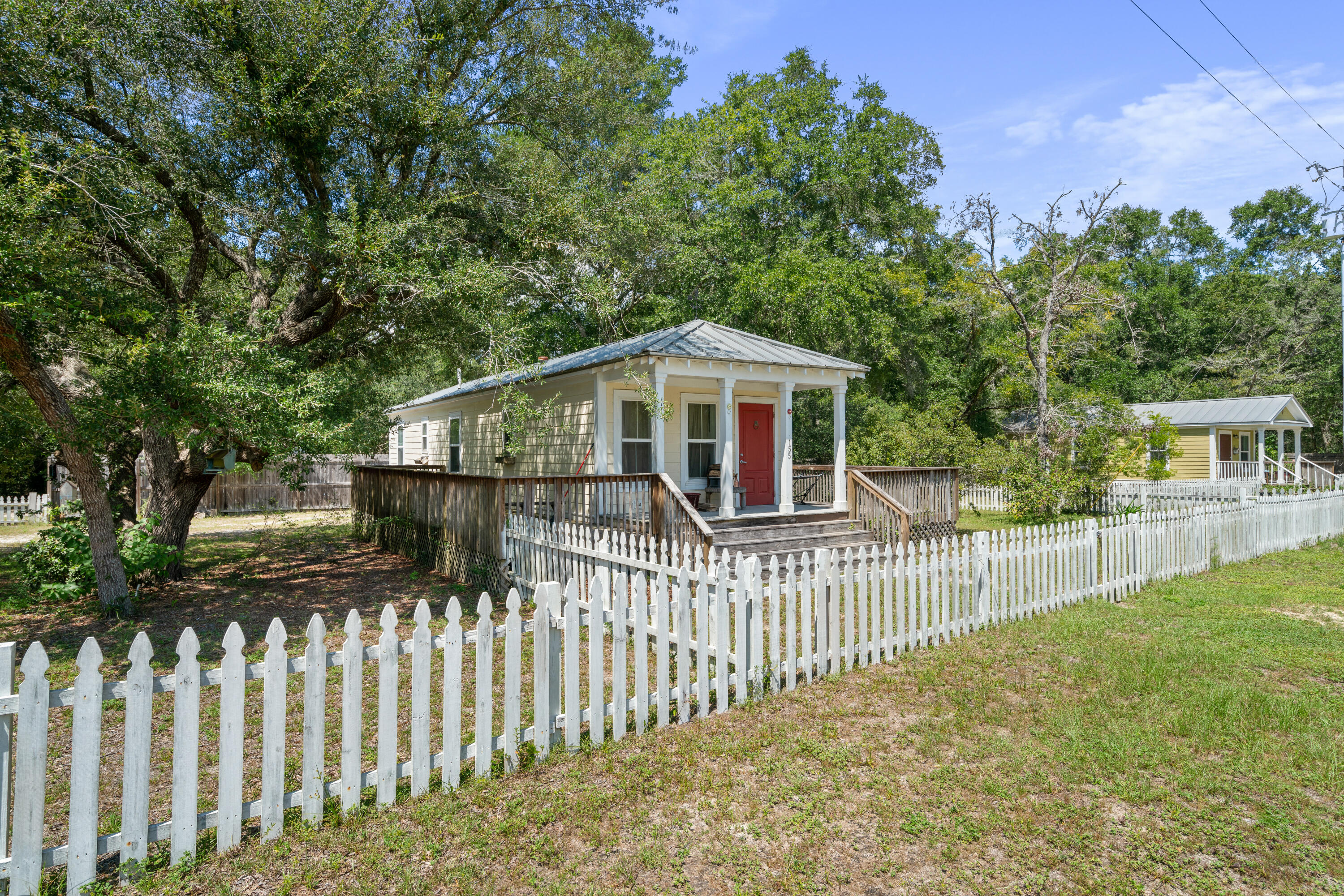 155-161 Caswell Branch Road Freeport, FL 32439 - Photo 2 of 24 a view of a house with a small yard and a large tree