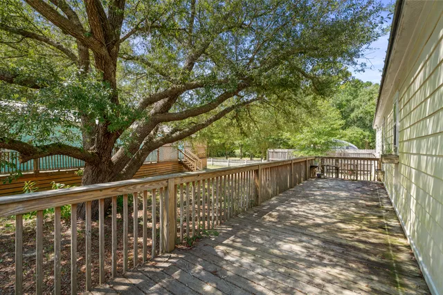 a view of balcony with wooden fence and trees