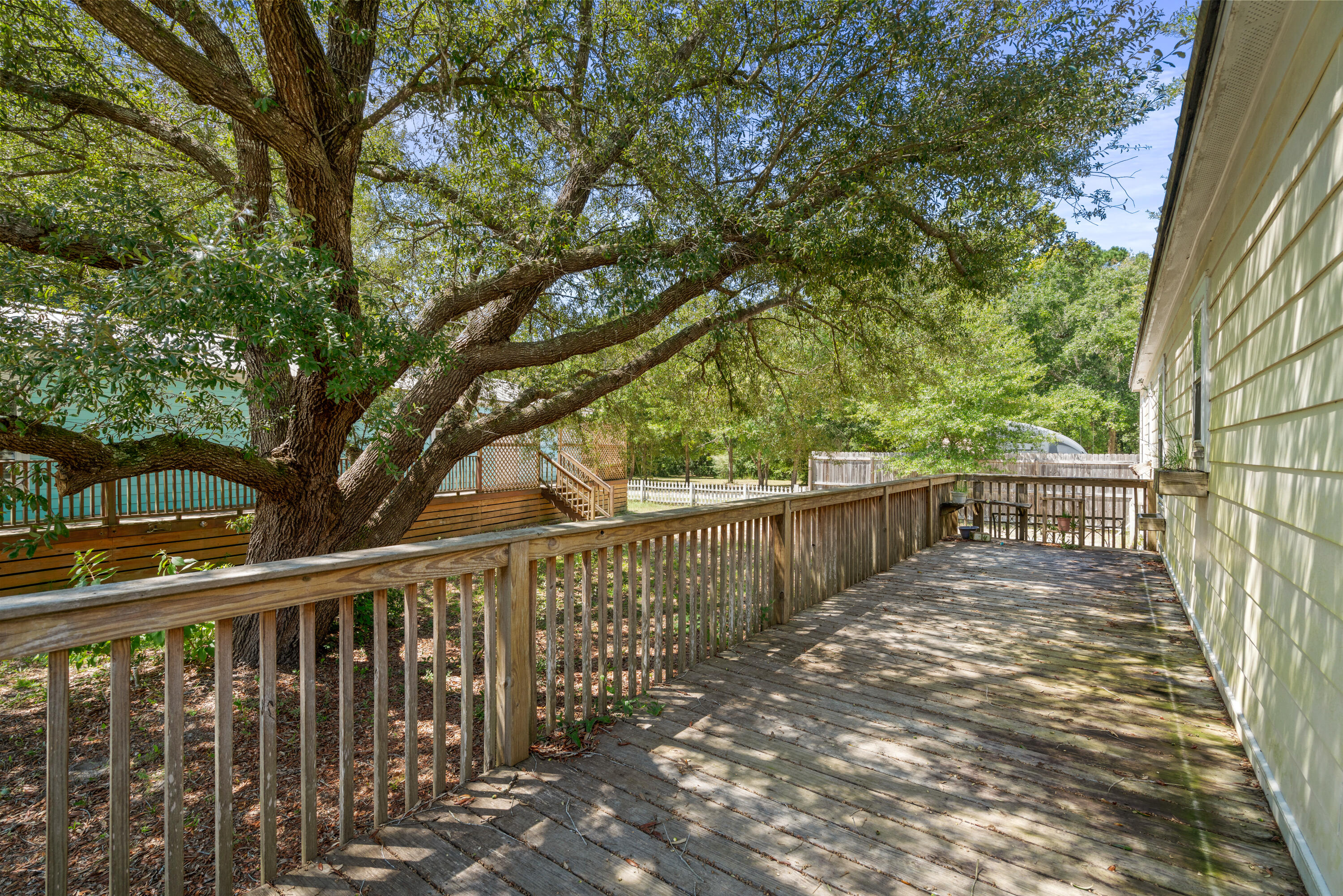 155-161 Caswell Branch Road Freeport, FL 32439 - Photo 4 of 24 a view of balcony with wooden fence and trees