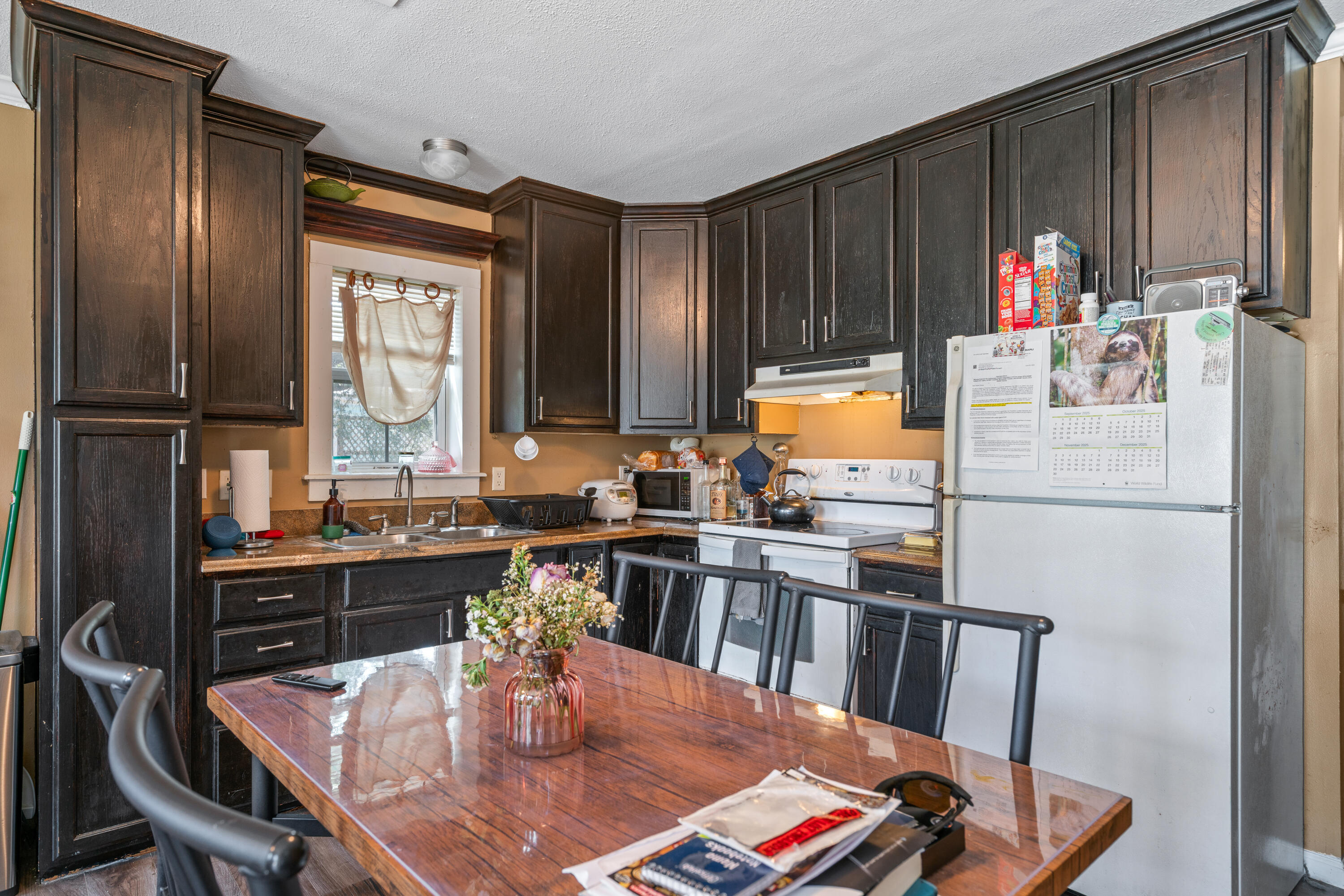 155-161 Caswell Branch Road Freeport, FL 32439 - Photo 6 of 24 a kitchen with stainless steel appliances wooden floor dining table and chairs
