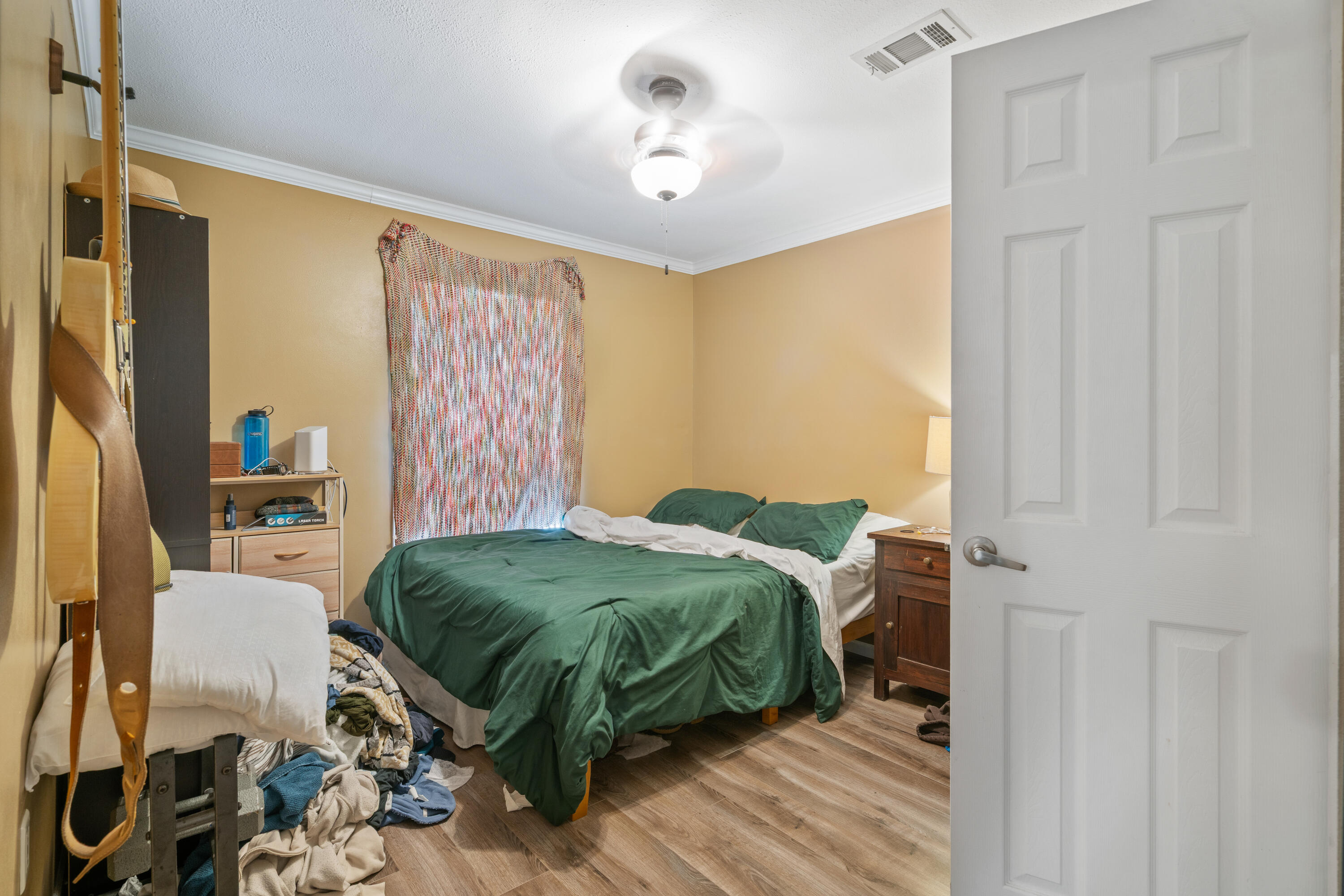 155-161 Caswell Branch Road Freeport, FL 32439 - Photo 9 of 24 a bedroom with a bed and a chandelier