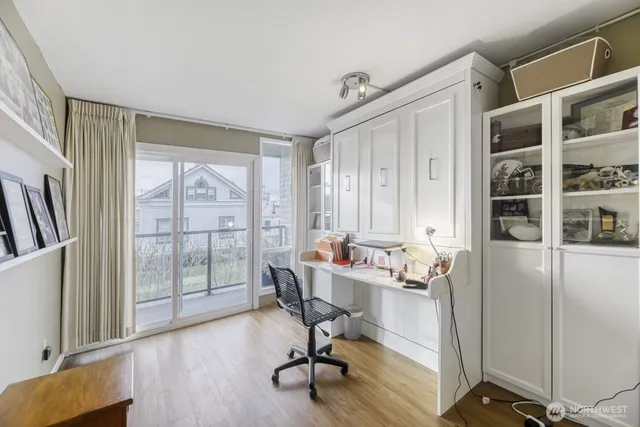 a view of a workspace with furniture and a window