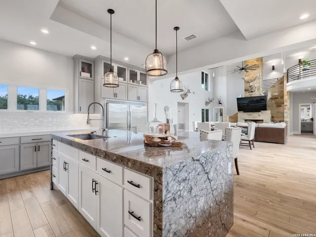 a spacious bedroom with a bed and a wooden floor